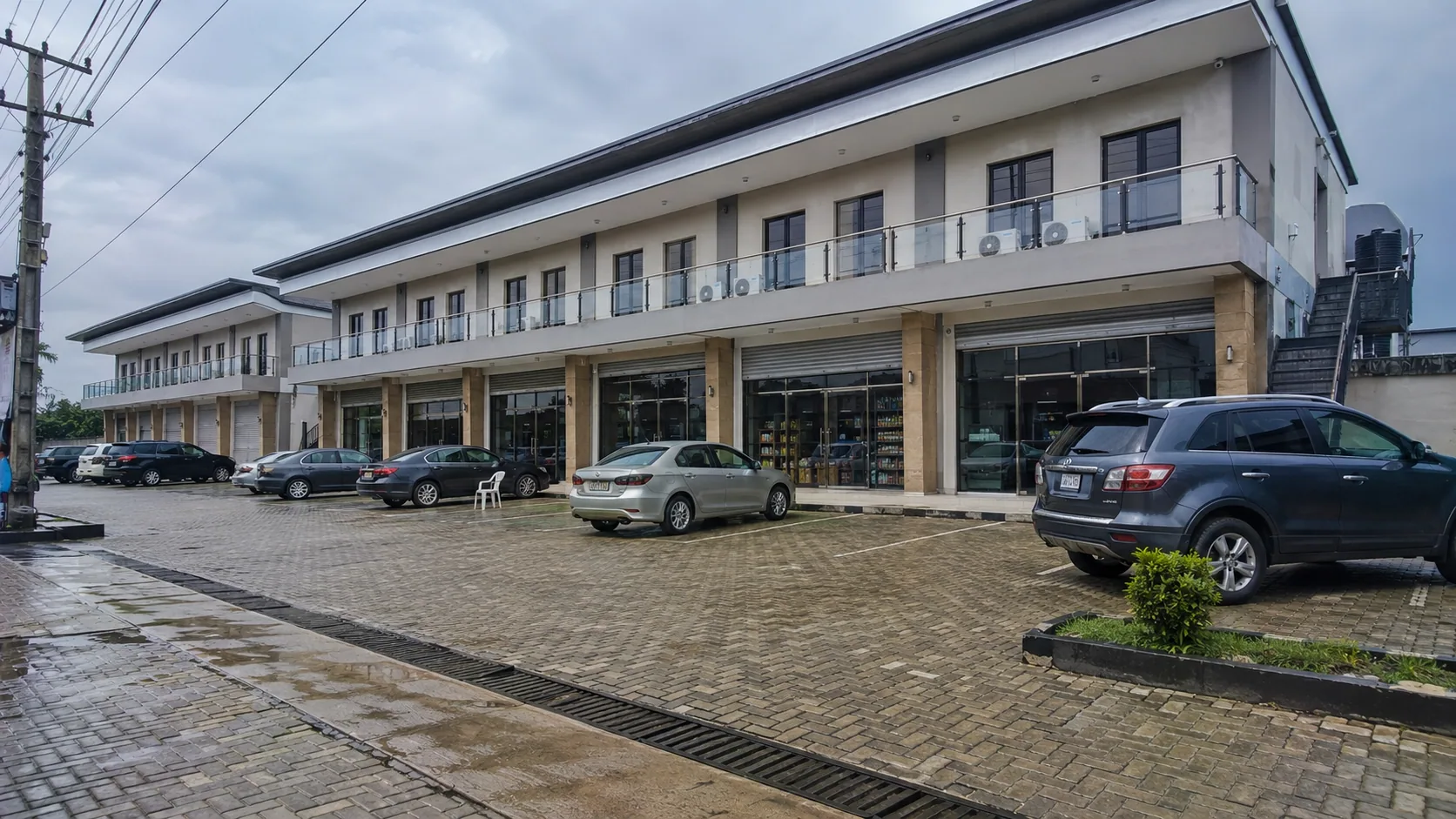 Completed two-storey commercial development with paved parking and glazed shopfronts